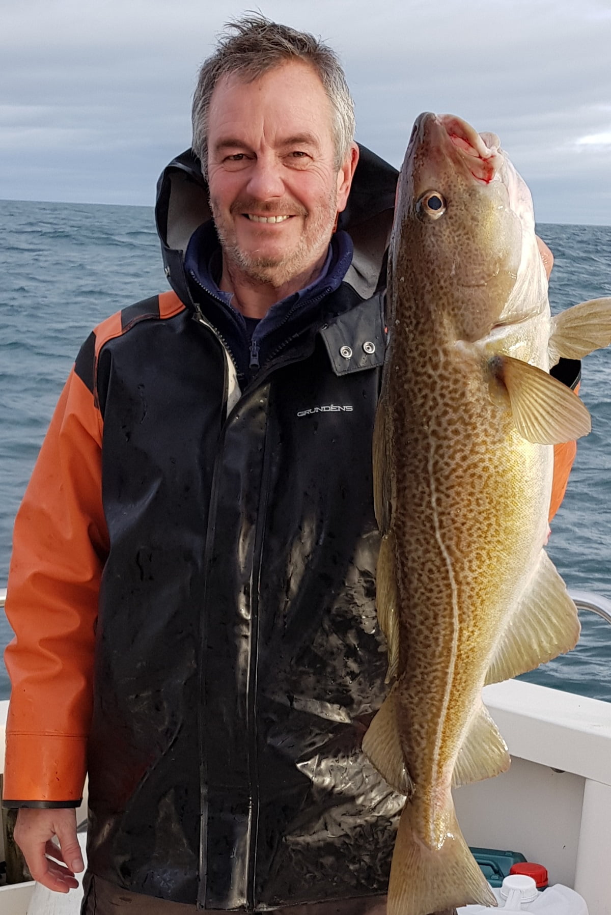 David, the Skipper, with a cod on charter boat Silver Dawn