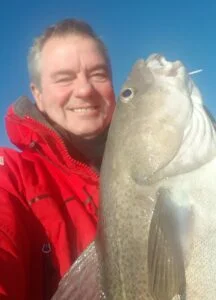 Cod being held with a smile on Silver Dawn