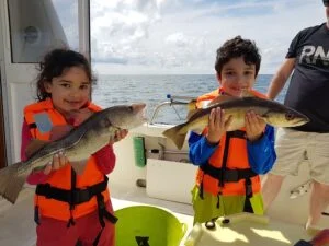 Fish caught for tea by young boy and girl